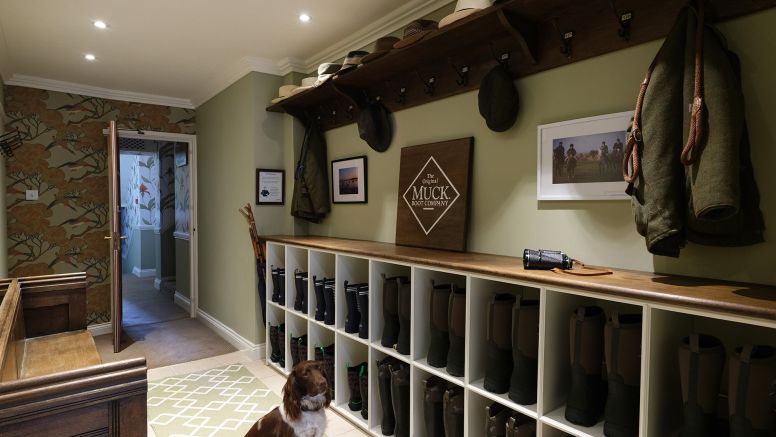 The Nare Boot Room with one of the hotel's hounds sat awaiting his next instruction