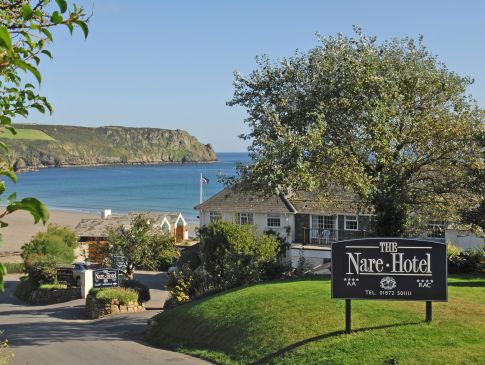 The entrance to The Nare, a luxury hotel in Cornwall, with the sea beyond.