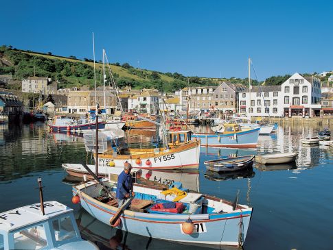 Mevagissey Harbour with a boat in the foreground.