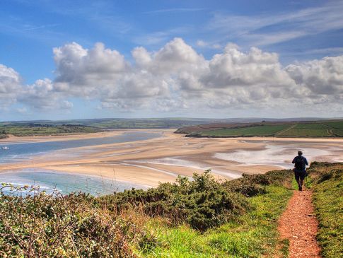 A man walks a path overlooking the Camel Valley in Cornwall.