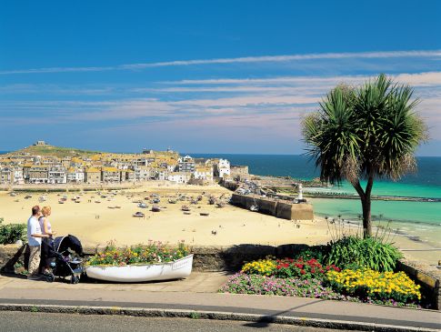 A couple look over St Ives Beach in Cornwall.