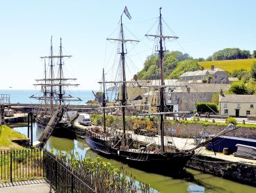 Tall ships anchored at Charlestown Harbour in Cornwall.