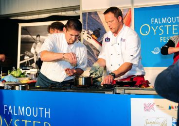 Two chefs give a cooking demonstration at the Falmouth Oyster Festival.