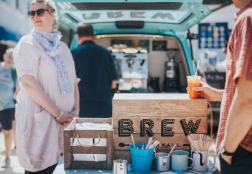 People standing at a food van at St Ives Food Festival in Cornwall.