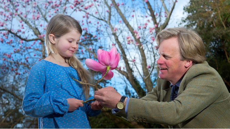 Toby Ashworth gives his daughter a pink magnolia flower.