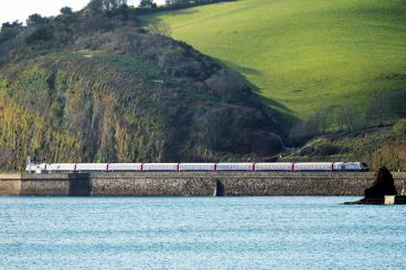 A train right by the sea in Cornwall.