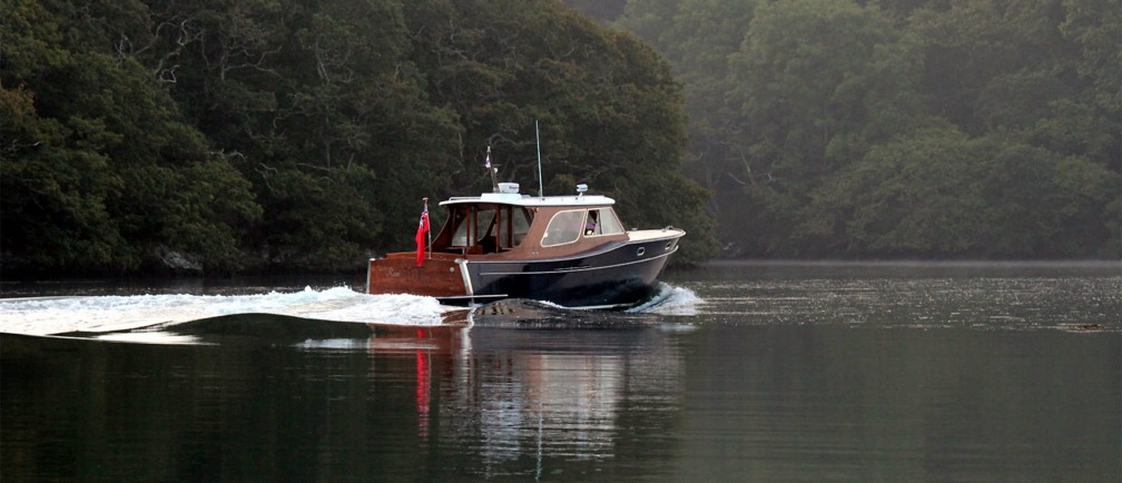 A boat sailing on glassy water.