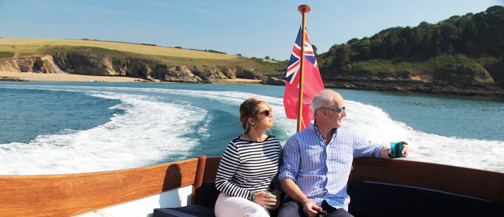 A couple enjoys the view from their motor launch.