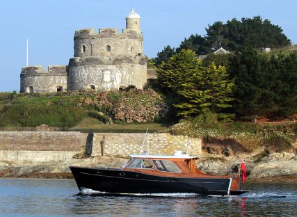 The Nare's motor launch sails past St Mawes castle