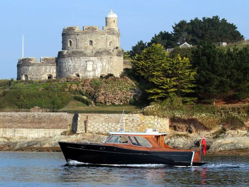 The Nare's motor launch sails past St Mawes castle