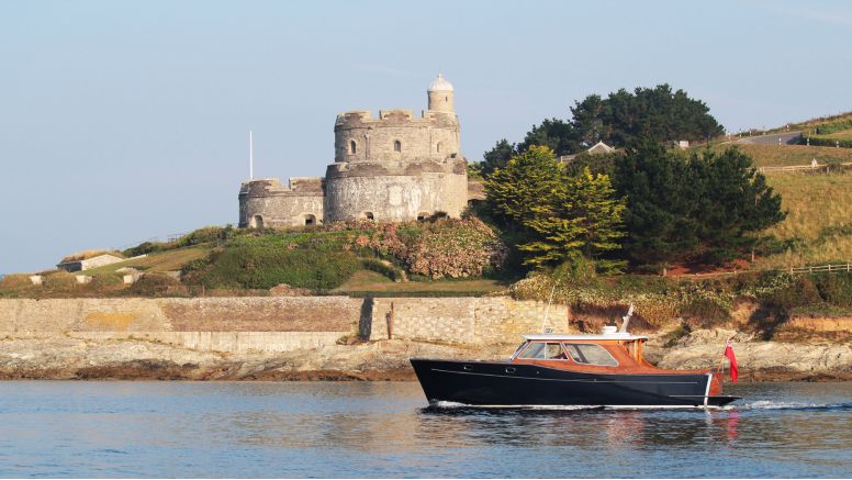 The Nare's motor launch sails past St Mawes castle