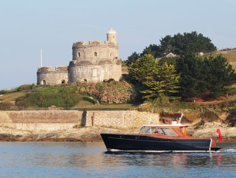 The Nare's motor launch sails past St Mawes castle