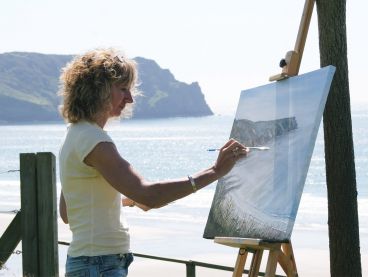 The Nare's artist in residence paints the coastal view from the hotel's gardens.