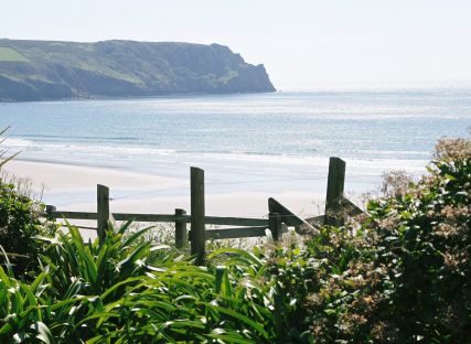 The Nare gardens with Carne Beach beyond.