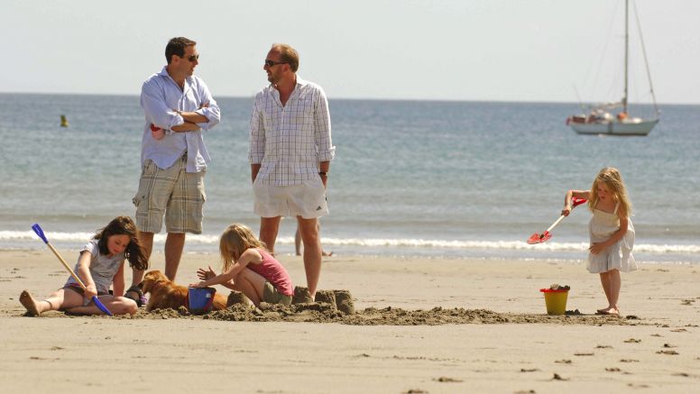 Holidaymakers enjoy the sun and sand at secret Cornwall beach, Carne Bay.