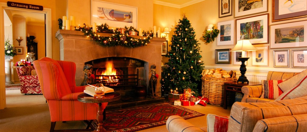 The Nare hotel, decorated for Christmas with a tree, festive adornments and an open fire.