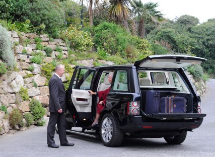 The Nare hotel's chauffeur helps a guest out of the hotel's private Range Rover.