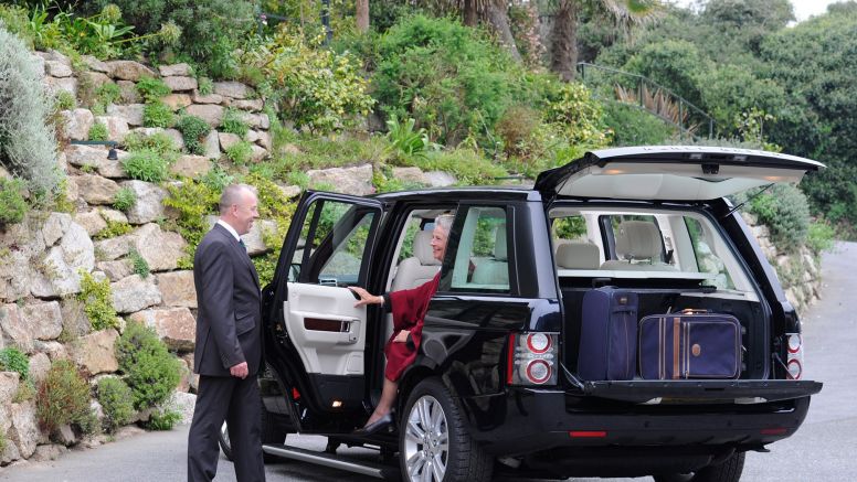 The Nare hotel's chauffeur helps a guest out of the hotel's private Range Rover.
