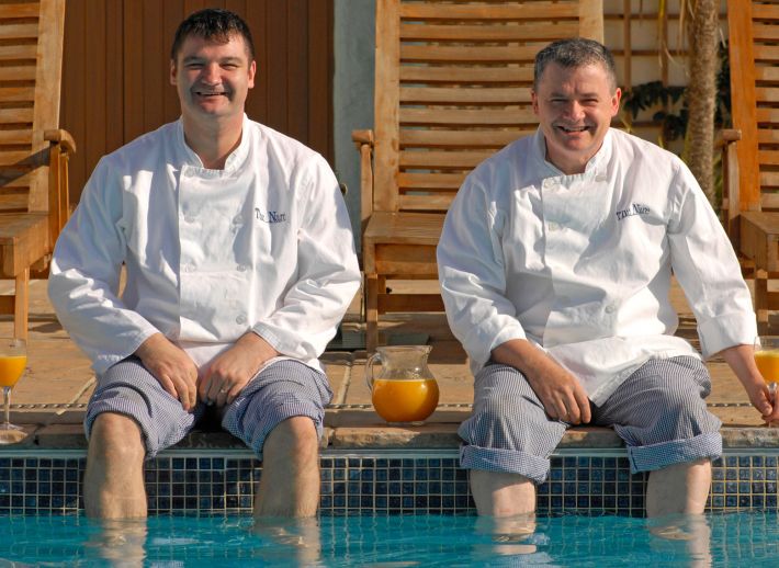 The chefs at The Nare dipping their feet in the hotel pool.
