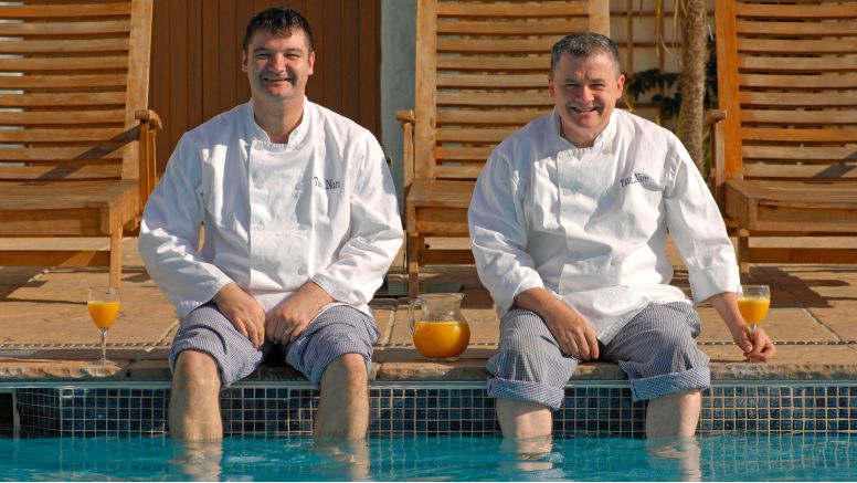 The chefs at The Nare dipping their feet in the hotel pool.