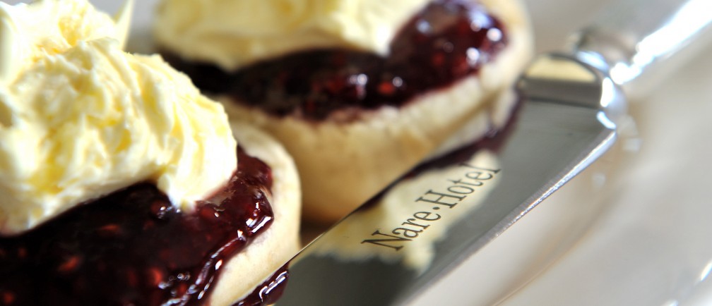 Scones with jam and topped with clotted cream.