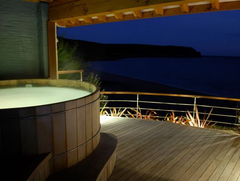 The Nare hotel's outdoor hot tub at night.