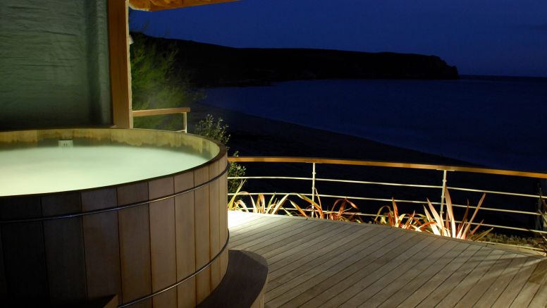 The Nare hotel's outdoor hot tub at night.