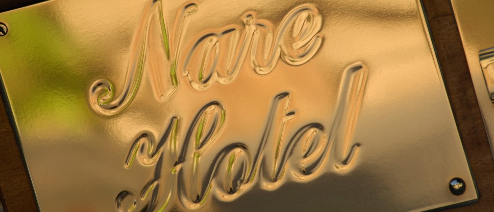 A golden embossed sign reading 'Nare Hotel.