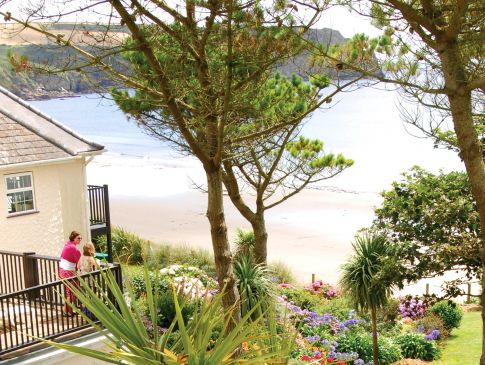 Guests enjoy the view of the sea from a terrace at The Nare hotel.