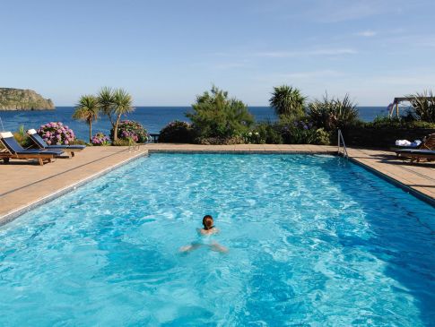 Someone swims in The Nare's outdoor pool.