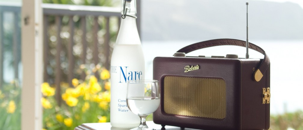 A bottle of water and a radio with sea gardens behind.