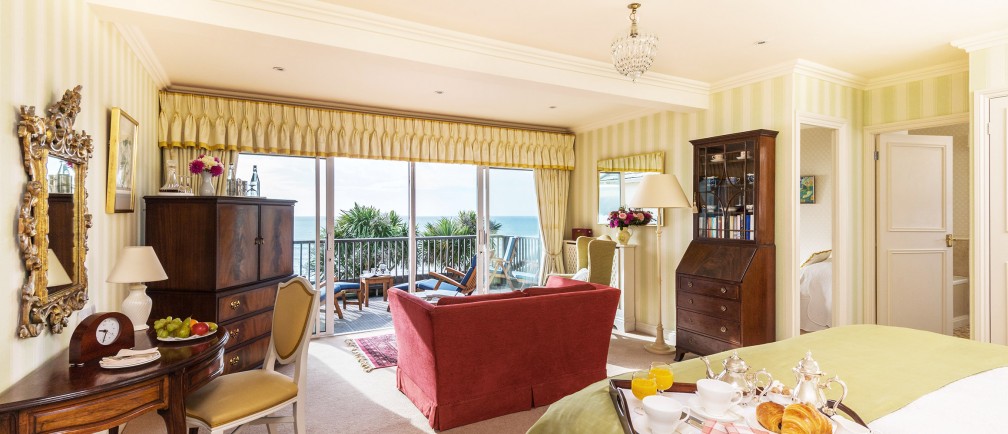 A hotel bedroom with a private sea-view balcony at The Nare hotel.