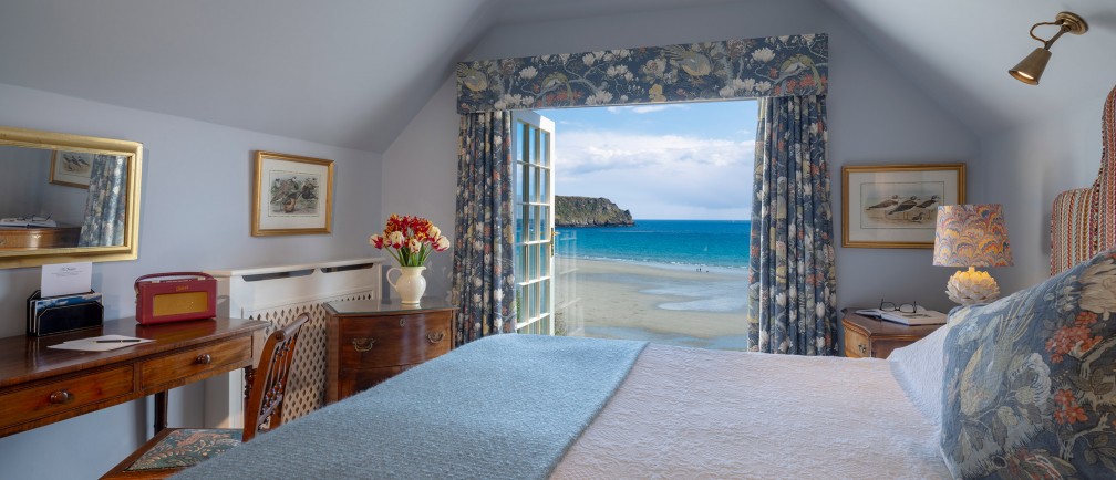 Sea views over Carne Beach from the first floor bedroom of Lemoria Cottage at The Nare Hotel