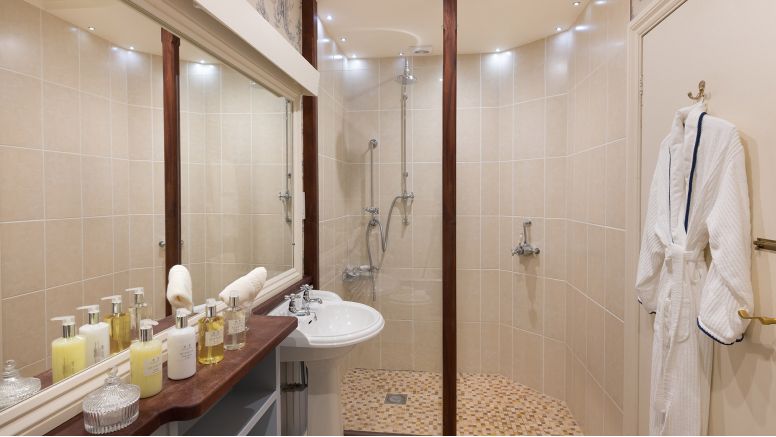 A bathroom with walk-in shower at The Nare hotel.