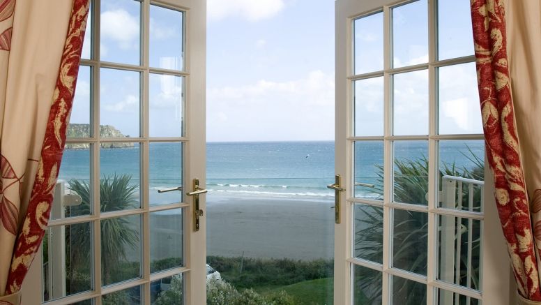 French doors opening out onto a sea-view balcony at The Nare hotel.