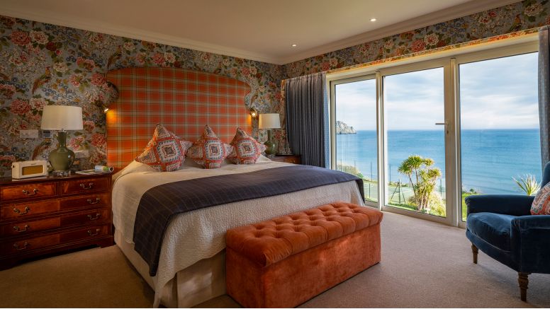 A master bedroom in a Grand Suite at The Nare Hotel with stunning sea views