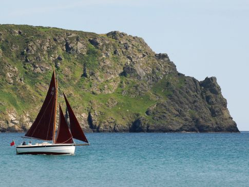 The Nare hotel's Cornish crabber yacht sails past Nare Head.