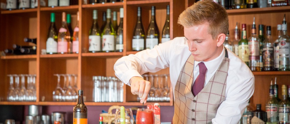 A barman mixes a drink at The Nare.