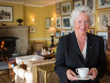 The Nare hotel's Maitre D', holding a cup of tea.