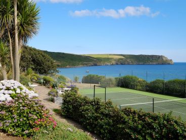 The Nare hotel's all-weather tennis court with stunning sea views.