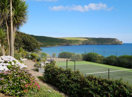 The Nare hotel's all-weather tennis court with stunning sea views.