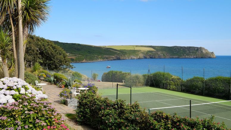 The Nare hotel's all-weather tennis court with stunning sea views.