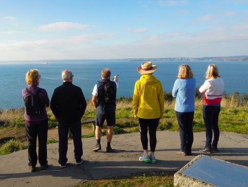 A group of guests taking in the view from St Anthony Head