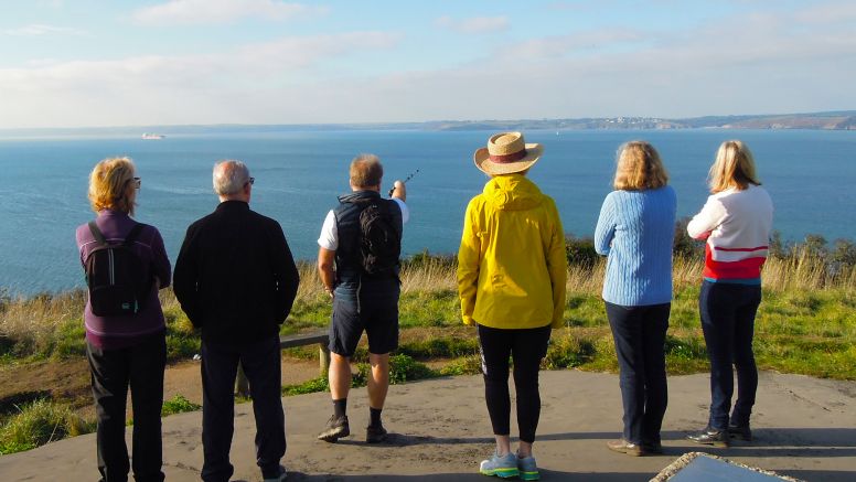 A group of guests taking in the view from St Anthony Head