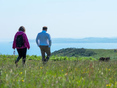 Two people walking the coast path in Cornwall