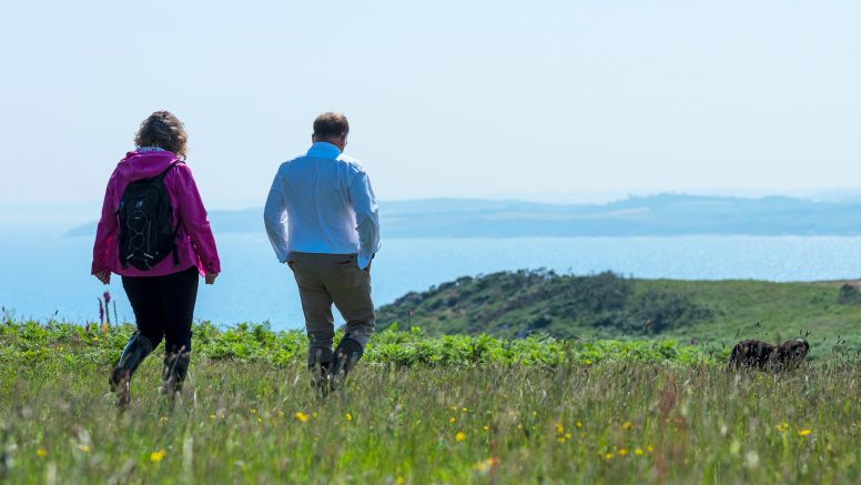 Two people walking the coast path in Cornwall